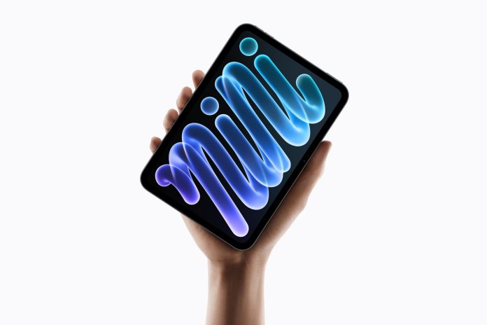 The new iPad mini held in the palm of a hand.